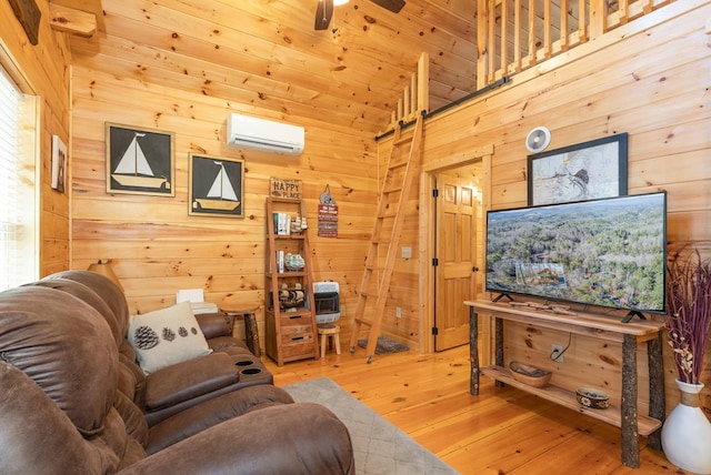 living area featuring a ceiling fan, wood ceiling, wooden walls, wood finished floors, and a wall mounted air conditioner