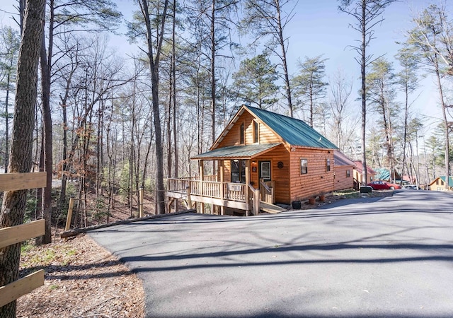 view of front of house featuring metal roof and a porch