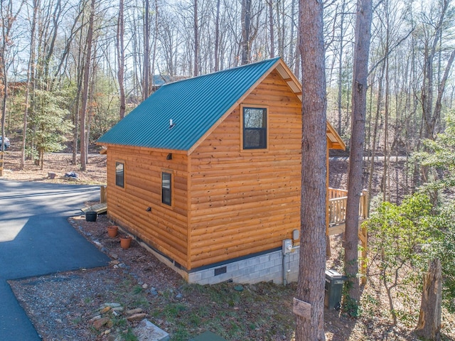 view of outbuilding featuring aphalt driveway