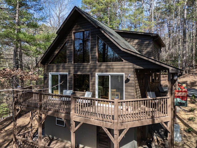 rear view of property with a wooden deck