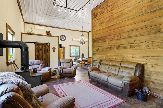 living room with an inviting chandelier, rail lighting, and wood walls