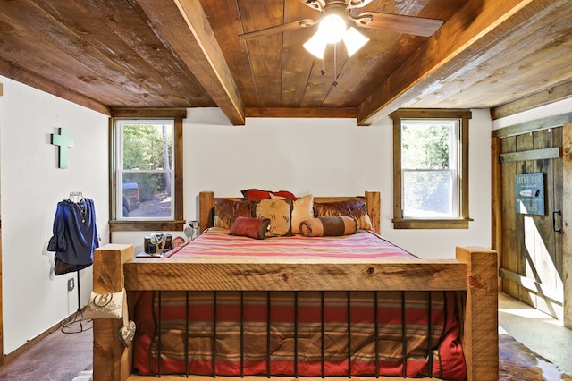 bedroom featuring multiple windows, wood ceiling, and beamed ceiling