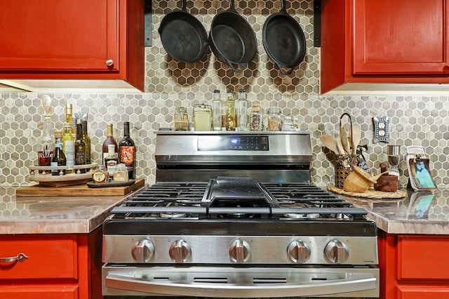 kitchen with gas range and backsplash