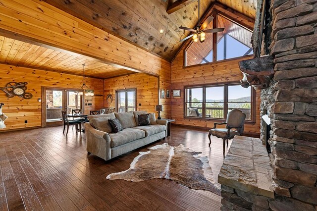 living room with wood walls, hardwood / wood-style flooring, and a wealth of natural light