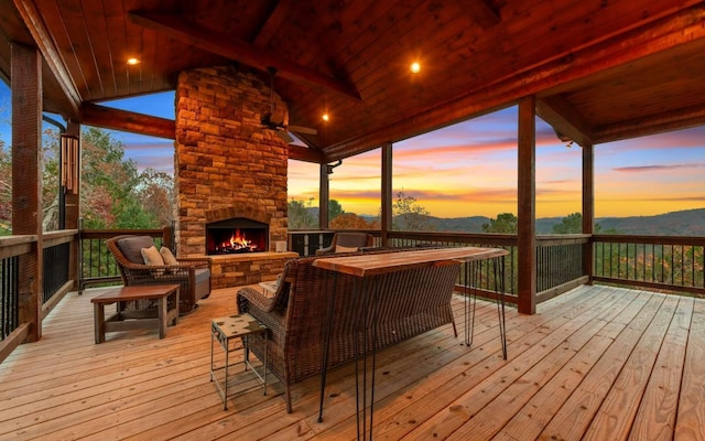 wooden terrace featuring an outdoor living space with a fireplace and ceiling fan