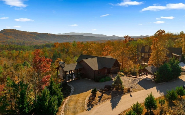 birds eye view of property with a view of trees and a mountain view