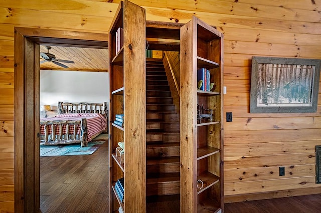 bedroom with wood walls and hardwood / wood-style flooring