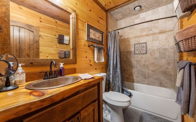 bathroom with wooden walls, toilet, shower / tub combo with curtain, and vanity