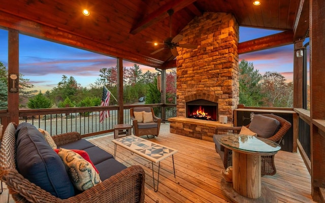 wooden terrace featuring an outdoor living space with a fireplace and ceiling fan