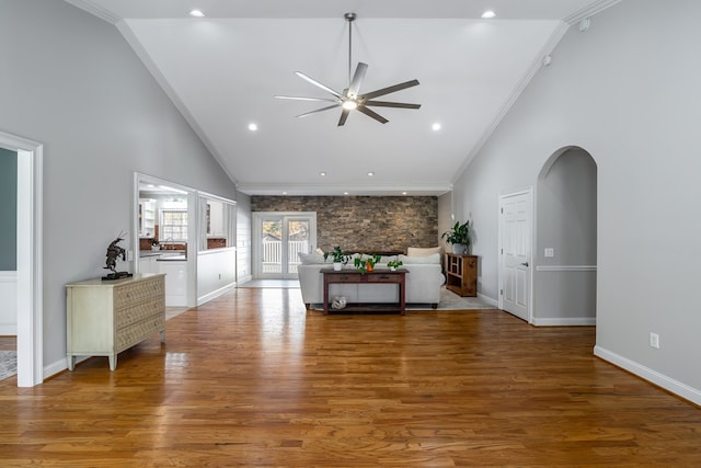 living area featuring crown molding, a ceiling fan, wood finished floors, and baseboards