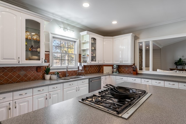 kitchen featuring appliances with stainless steel finishes, white cabinetry, and a sink