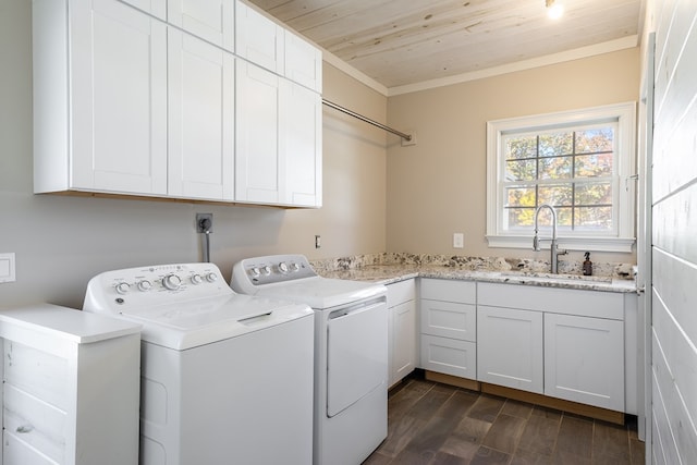 clothes washing area featuring wood ceiling, cabinet space, washing machine and clothes dryer, dark wood-style flooring, and a sink