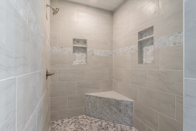 bathroom featuring a tile shower