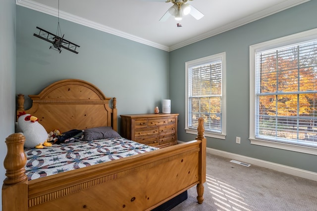 carpeted bedroom with baseboards, visible vents, ceiling fan, and crown molding