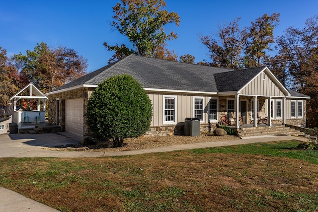 exterior space with board and batten siding, a porch, driveway, and stone siding