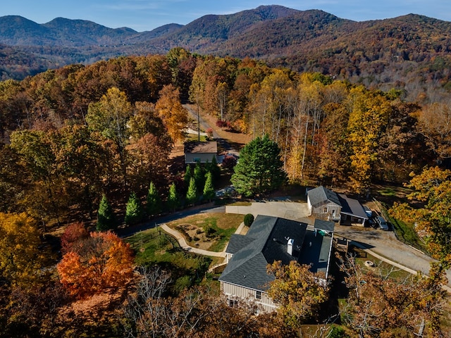 birds eye view of property with a mountain view and a view of trees