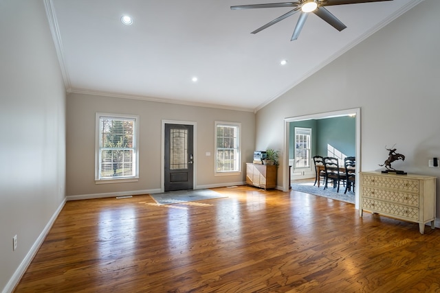 foyer entrance with wood finished floors, ceiling fan, ornamental molding, and baseboards