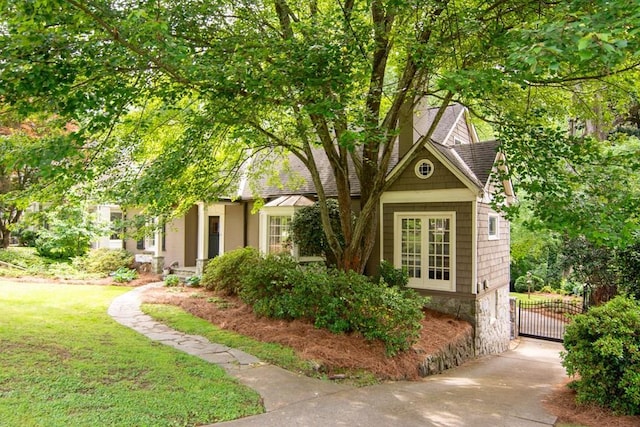exterior space featuring a gate and a yard