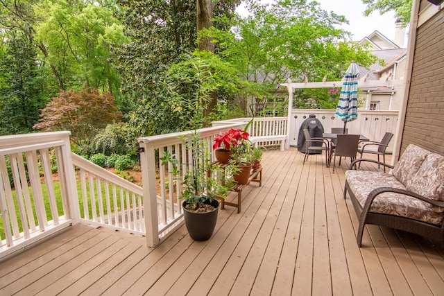 wooden deck featuring outdoor dining area