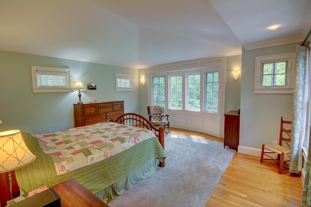 bedroom featuring baseboards and light wood-style flooring
