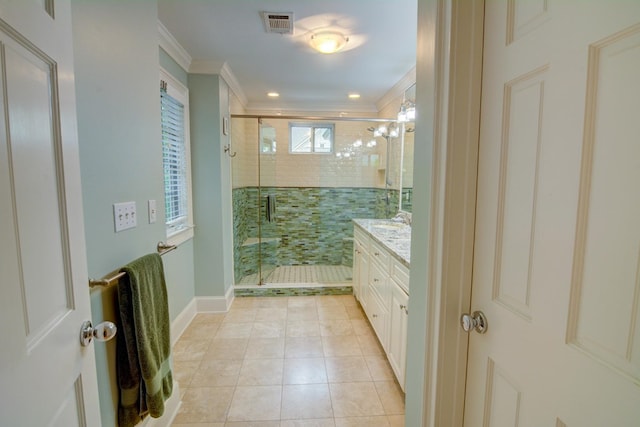 full bath with crown molding, vanity, tile patterned floors, a shower stall, and visible vents
