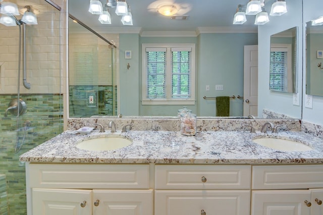 full bath featuring crown molding, a sink, and a shower stall