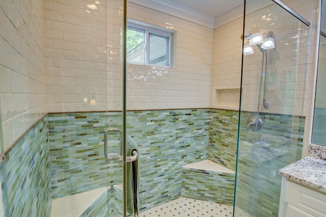 full bath featuring vanity, ornamental molding, and a stall shower