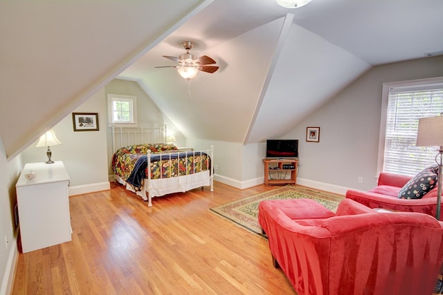 bedroom with baseboards, ceiling fan, vaulted ceiling, and light wood finished floors