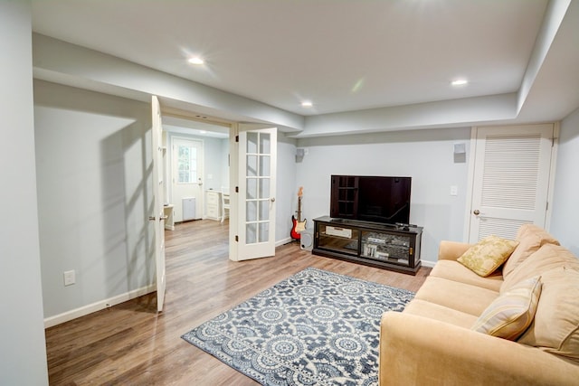 living room with recessed lighting, baseboards, and wood finished floors