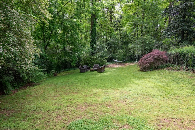 view of yard with a view of trees and fence