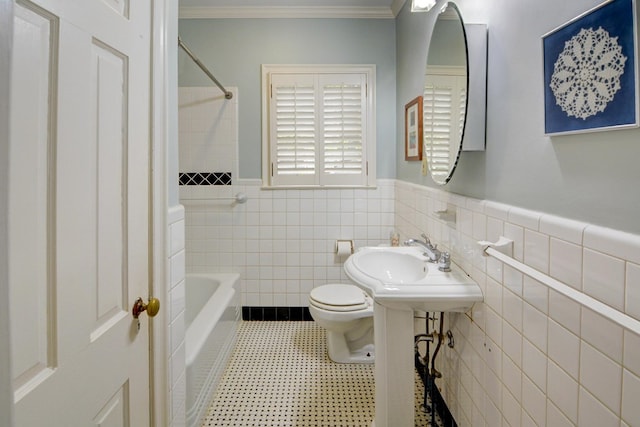 full bathroom featuring wainscoting, toilet, shower / bath combination, tile walls, and ornamental molding
