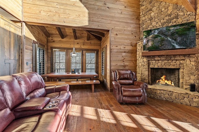 living room featuring a fireplace, beamed ceiling, wooden walls, hardwood / wood-style flooring, and wooden ceiling