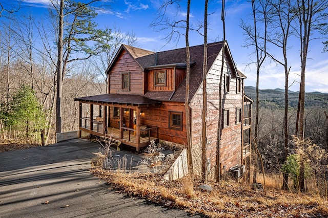 view of front of home with cooling unit and covered porch