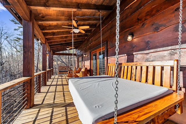 wooden deck featuring ceiling fan