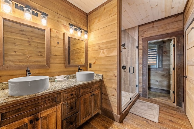 bathroom with walk in shower, vanity, wood walls, hardwood / wood-style flooring, and wood ceiling