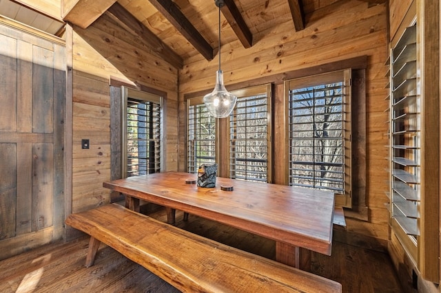 unfurnished dining area with wood ceiling, plenty of natural light, wood walls, and beamed ceiling