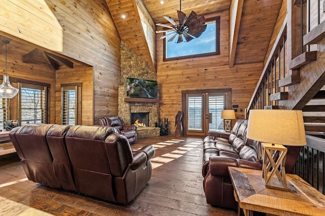 living room with high vaulted ceiling, ceiling fan, wood ceiling, and a fireplace