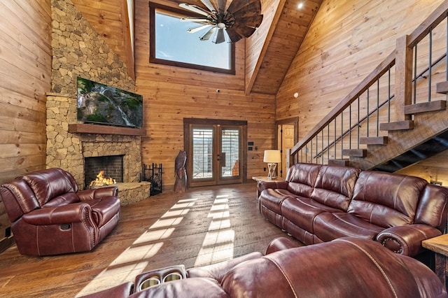 living room with a fireplace, hardwood / wood-style flooring, wood ceiling, high vaulted ceiling, and french doors