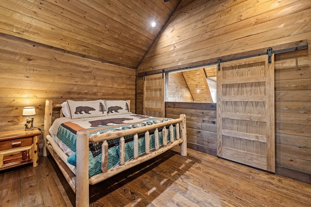 bedroom featuring a barn door, vaulted ceiling, wood walls, wood-type flooring, and wooden ceiling