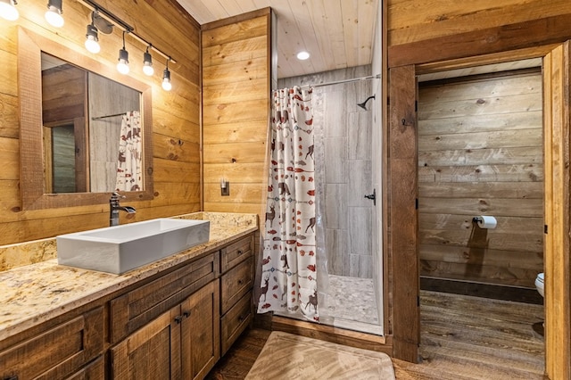 bathroom featuring wooden walls and a shower with shower curtain