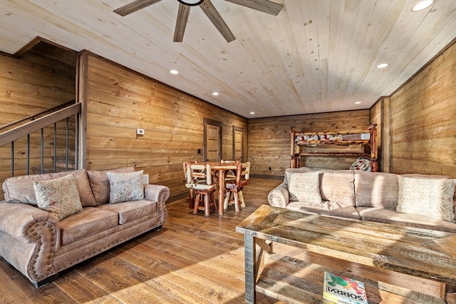 interior space with wood walls, wooden ceiling, hardwood / wood-style flooring, and ceiling fan