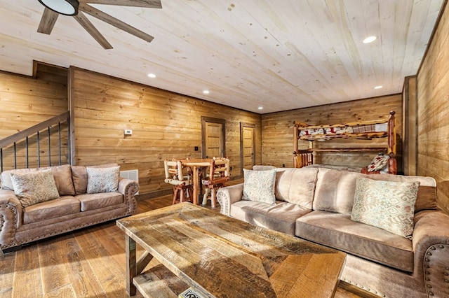 living room featuring wooden ceiling, ceiling fan, wooden walls, and hardwood / wood-style floors