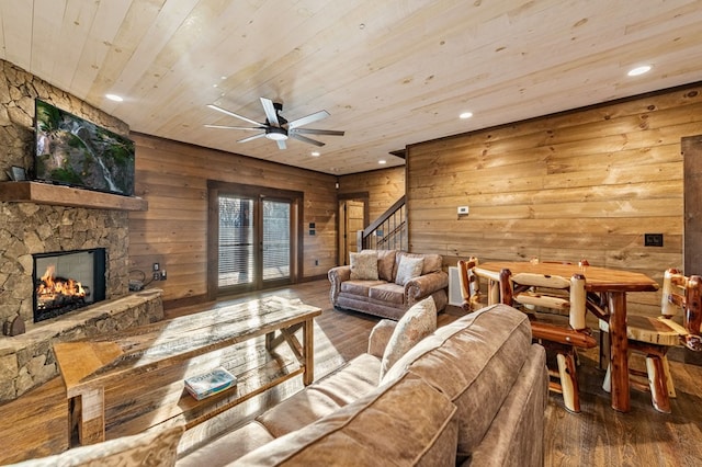 living room with a fireplace, ceiling fan, wood walls, hardwood / wood-style flooring, and wooden ceiling