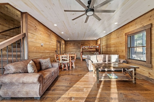 living room featuring ceiling fan, hardwood / wood-style flooring, wood walls, and wooden ceiling