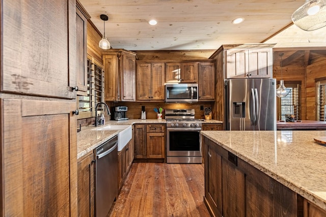 kitchen featuring wooden ceiling, appliances with stainless steel finishes, hanging light fixtures, and wooden walls