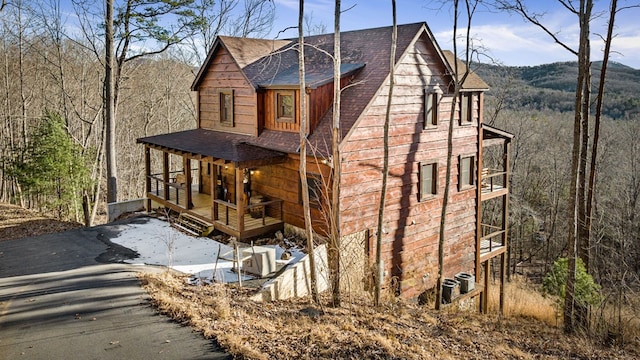 view of front of home with cooling unit and a porch