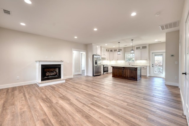 unfurnished living room featuring light hardwood / wood-style flooring