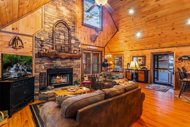 living room with wood ceiling, light hardwood / wood-style floors, and high vaulted ceiling