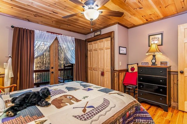 bedroom featuring ceiling fan, access to exterior, light hardwood / wood-style floors, a closet, and wooden ceiling