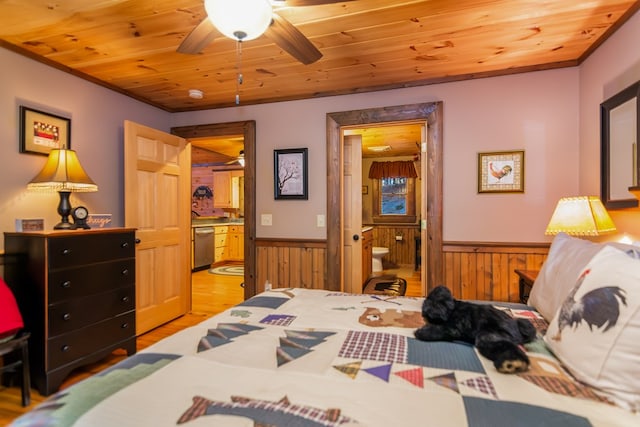 bedroom with ceiling fan, ensuite bathroom, and wood ceiling